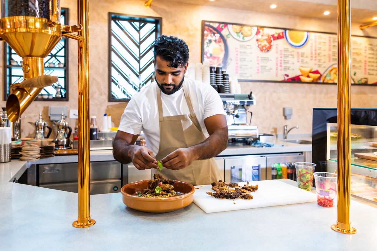 The chef at S34 Gahwa Mezza Bar in DXB prepares a dish from the inspiring menu.