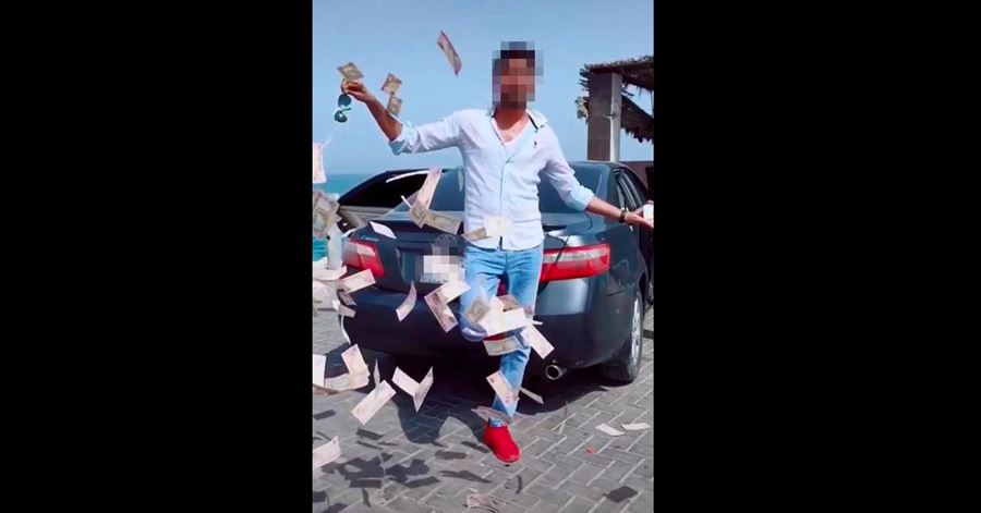 man arrested dubai throwing cash